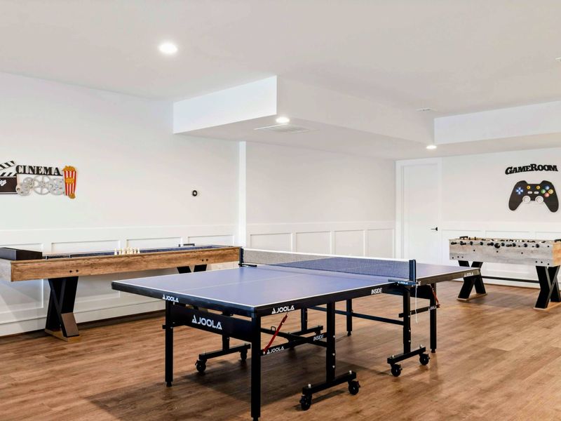 Game Room - Ping pong, shuffleboard, and foosball lined up for tournament-grade rivalry. Lake oars on the wall keep the energy going.