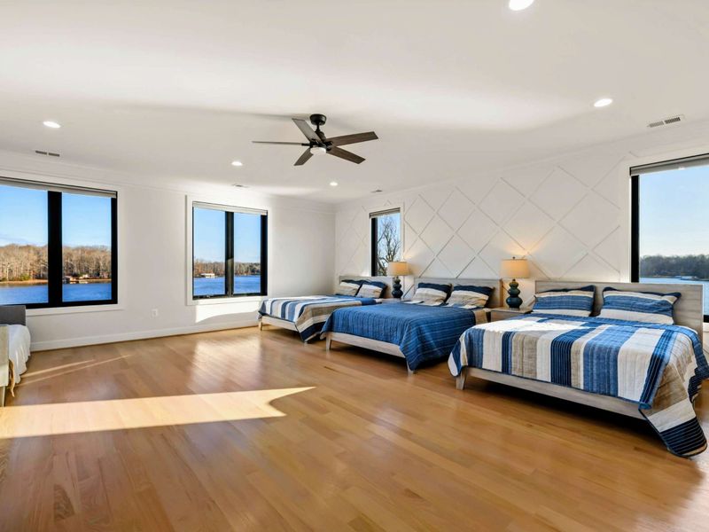 Suite #2 - Three beds (one queen, two doubles) and lake-view windows on two walls. Plenty of room for a family or three friends.