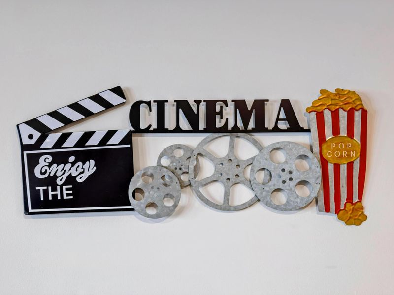 Movie Theater - Cinema-themed decor sets the mood: clapperboard, reel art, popcorn print. Welcome to movie night.
