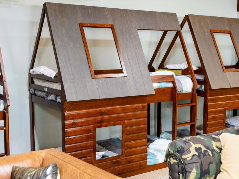 The Game Room features charming cabin-style bunk beds that add a playful and cozy touch, perfect for kids or the young at heart.
