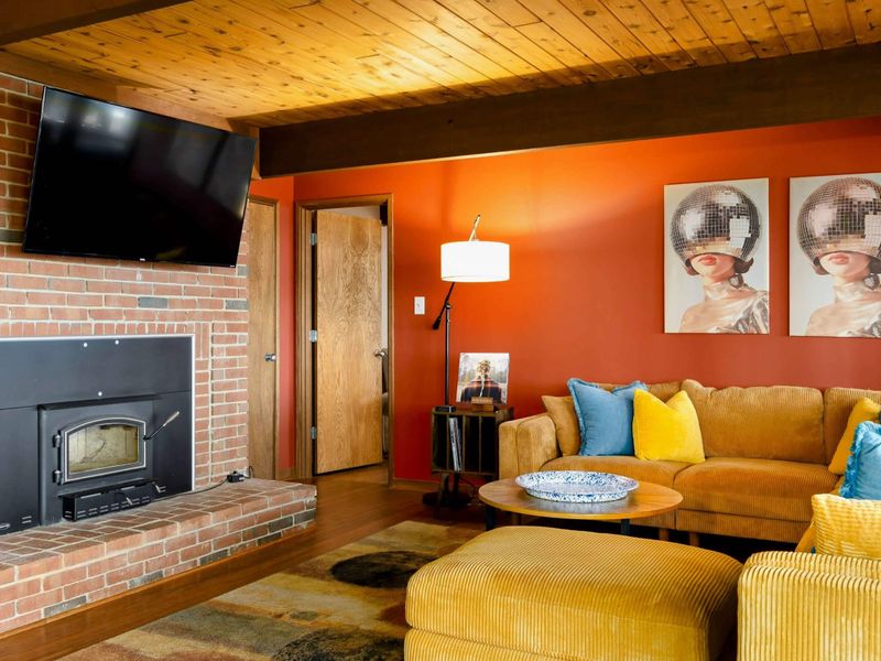 A cozy seating area with mounted TV, creating a perfect spot for relaxation and entertainment.