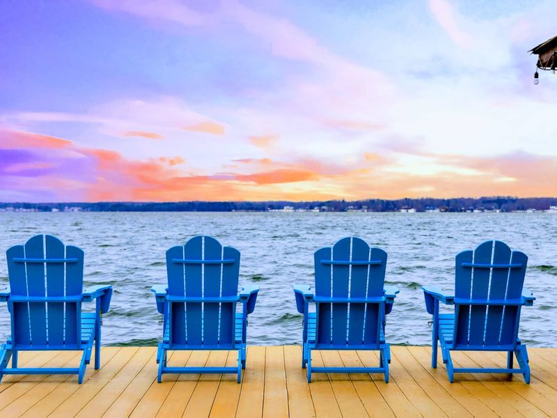Unwind in Adirondack chairs on the dock, soaking in stunning sunset views over the serene lake.