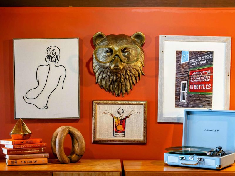 A stylish vignette featuring unique artwork, a vintage-inspired record player, and curated decor adds personality and charm to the space.