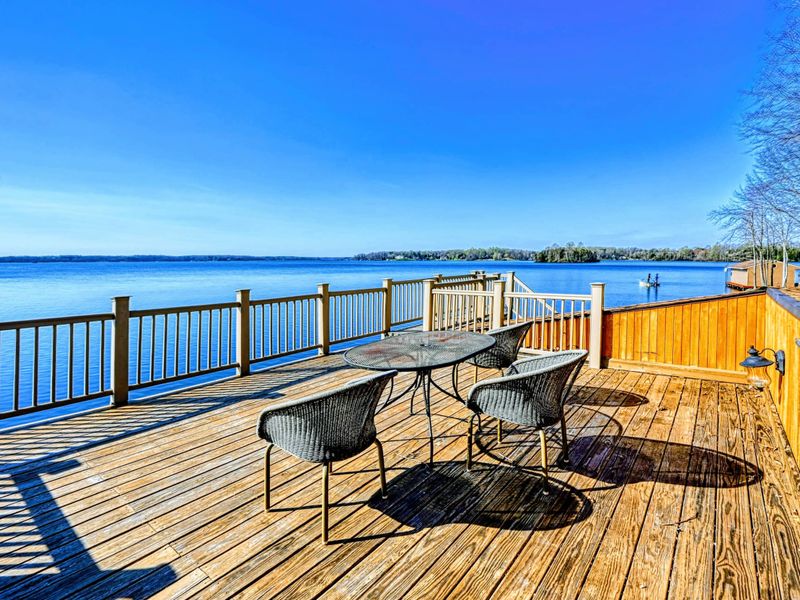 Spacious rooftop deck atop the boathouse with outdoor seating and breathtaking panoramic lake views.
