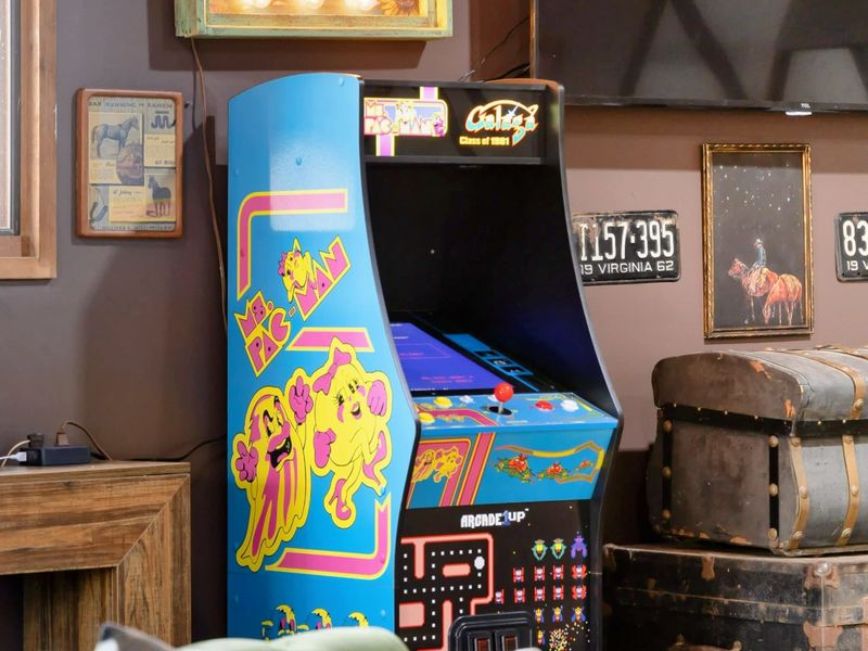 The Game Room features a retro Ms. Pac-Man arcade machine for nostalgic fun, complemented by charming western-inspired décor that creates a unique and playful atmosphere.