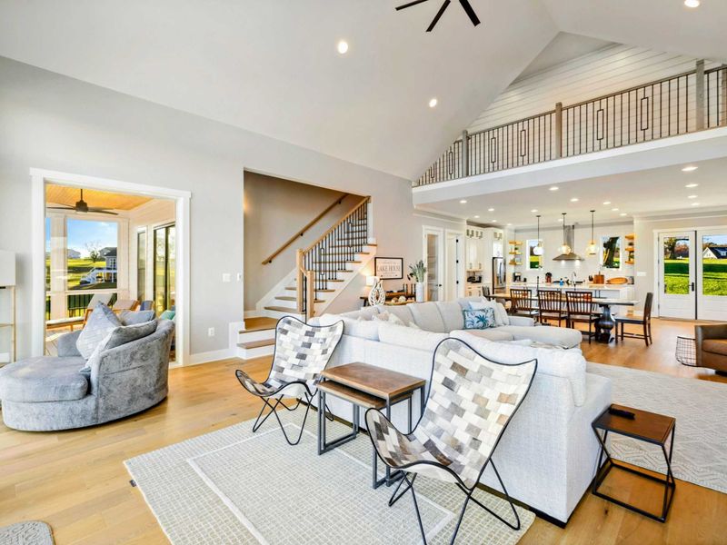 Spacious open-concept kitchen and living area with vaulted ceilings, modern fixtures, and abundant natural light.