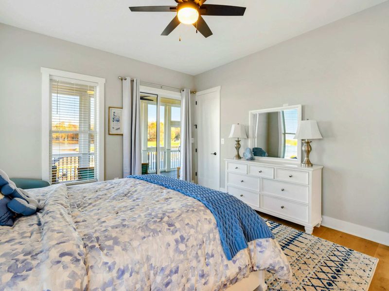 A bright and charming bedroom with lake views, cozy decor, and shared access to a convenient Jack and Jill bathroom.