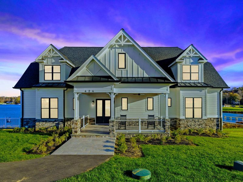 Stunning lakeside home with a modern farmhouse design, expansive front porch, and picturesque water views.