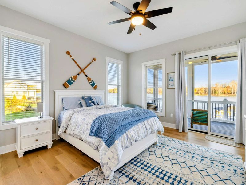 A bright and charming bedroom with lake views, cozy decor, and shared access to a convenient Jack and Jill bathroom.
