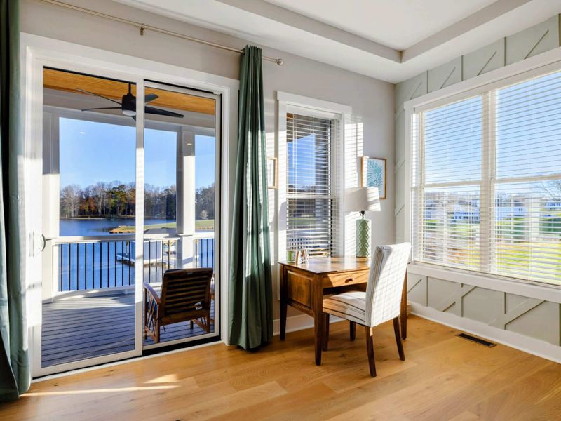 A luxurious and spacious primary bedroom with elegant furnishings, abundant natural light, a private balcony, and an en-suite bathroom.