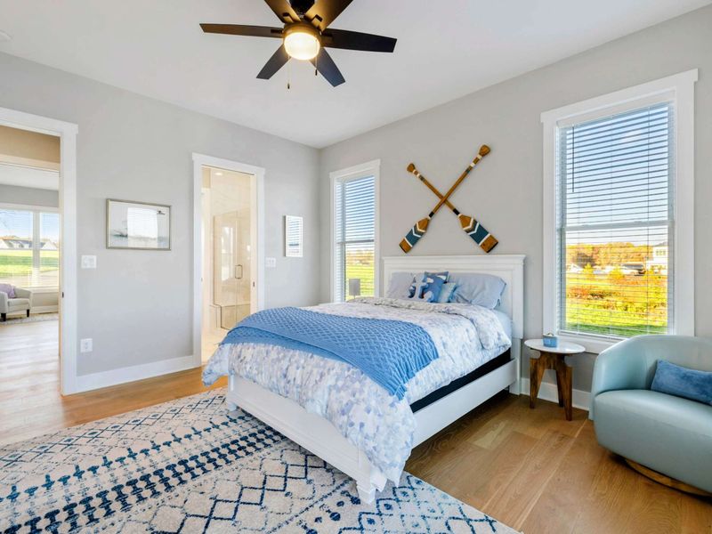 A bright and charming bedroom with lake views, cozy decor, and shared access to a convenient Jack and Jill bathroom.