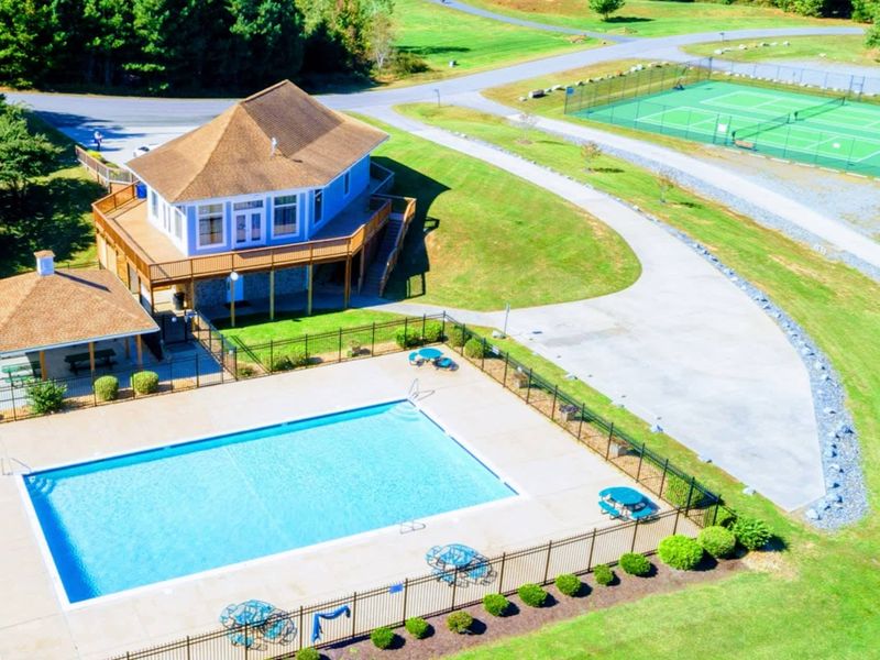 The rental includes access to The Waters community amenities, including a marina, swimming pool, tennis courts, picnic pavilions, a playground, and a sandy beach with lakefront views.