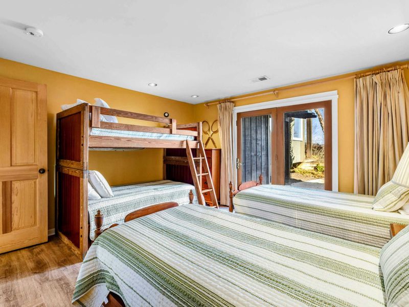 Bedroom 5 with Ensuite, Twin Beds & Bunk Bed - This spacious bedroom features two twin beds, a bunk bed, and an ensuite bathroom. With direct patio access and cozy decor, it's a perfect space for kids or groups to relax and enjoy Lake Anna.