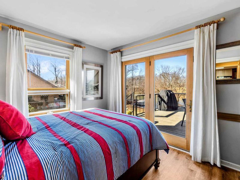 Cozy Bedroom 4 with Deck Access - This inviting bedroom features a plush bed, bright natural light, and direct access to a private deck. Enjoy peaceful mornings and fresh air while taking in the beautiful surroundings of Lake Anna.