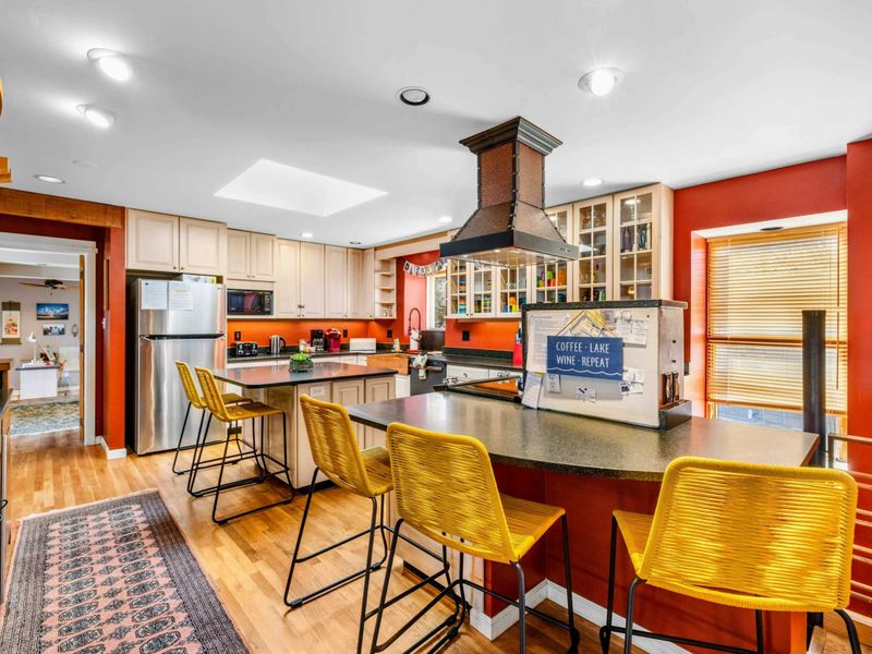 Spacious Kitchen with Bar Seating - This open-concept kitchen features a large bar with seating, modern appliances, and stylish decor. Perfect for cooking, entertaining, and gathering with friends and family at Lake Anna.
