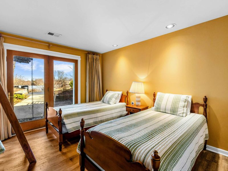Bedroom 5 with Ensuite, Twin Beds & Bunk Bed - This spacious bedroom features two twin beds, a bunk bed, and an ensuite bathroom. Enjoy direct patio access with beautiful Lake Anna views, making it a perfect retreat for kids or groups.