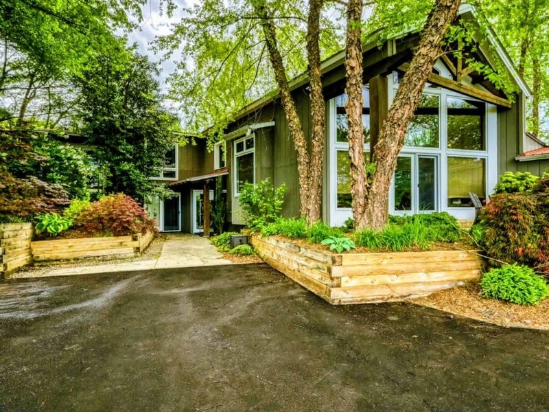 Admire the charming exterior of your home, nestled among tall trees and vibrant foliage, just steps from Lake Anna.