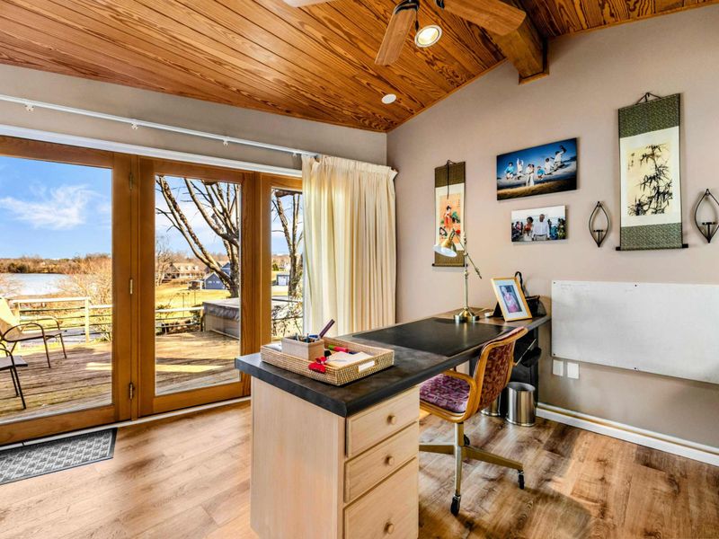 Scenic Office with Private Patio Access - Work with a view in this serene office featuring warm wood accents, a spacious desk, and direct access to a private patio. Enjoy natural light and stunning Lake Anna views right from your workspace.