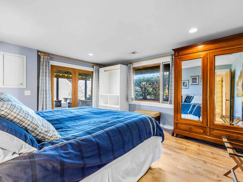 Bright Bedroom 2 with Patio & Garden Views - This inviting bedroom features a plush king bed, large windows with serene garden views, and direct access to a covered patio. A perfect retreat for rest and relaxation near Lake Anna.