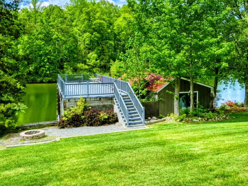 Discover your private retreat overlooking the serene shores of Lake Anna, with a charming deck nestled amidst lush greenery.