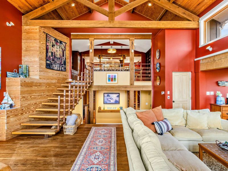 This beautifully designed space features soaring wood-beamed ceilings, a floating staircase, and multiple levels for relaxing and entertaining. The perfect blend of warmth, charm, and modern elegance.