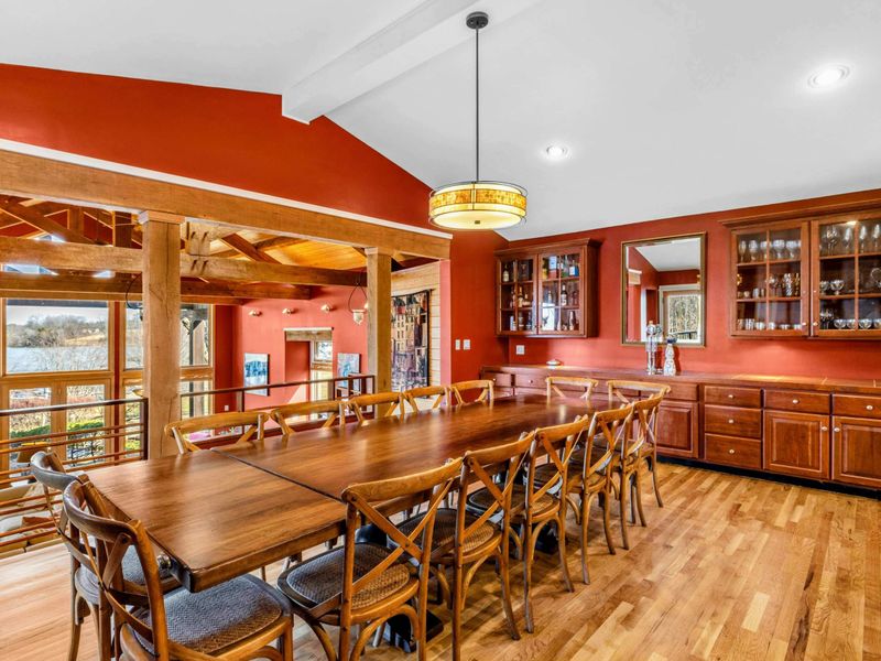 Spacious Dining Area with Lake Views - Gather around the large dining table with seating for twelve, perfect for family meals and celebrations. Enjoy the warm wood accents, built-in cabinetry, and scenic views overlooking the Great Room.