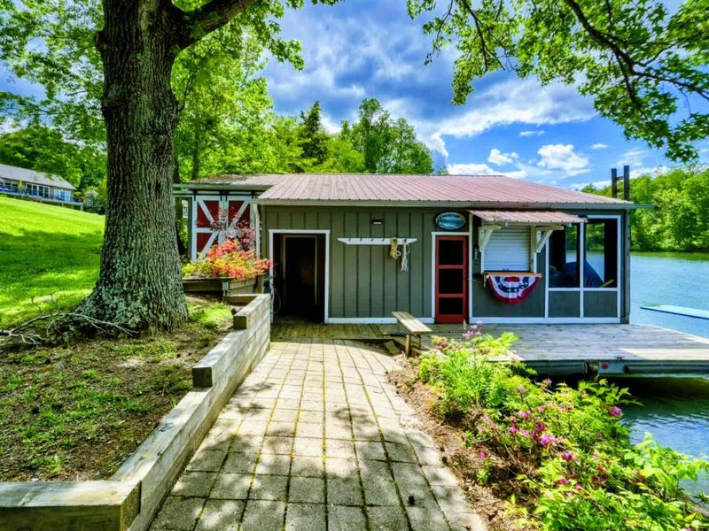 This picturesque boathouse by Lake Anna invites you to embrace lakeside living, perfect for storing your gear or soaking up the views.