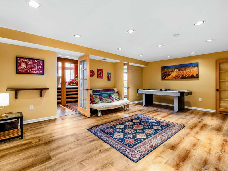 Enjoy fun and relaxation in this bright and open game room featuring an air hockey table, cozy seating, and stylish decor. A perfect space for entertainment, family time, or unwinding after a day on Lake Anna.