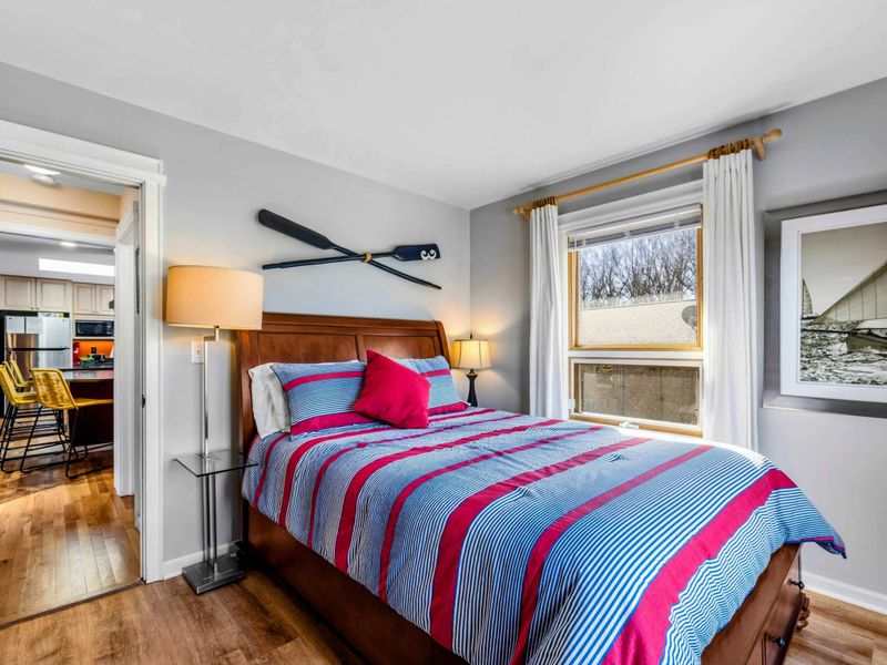 Charming Bedroom 4 with Nautical Accents - This cozy bedroom features a plush bed, bright natural light, and nautical-inspired decor. Conveniently located near the kitchen, it's a perfect retreat for a restful night's sleep at Lake Anna.