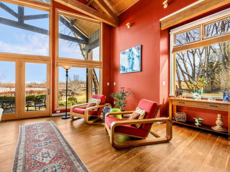 Unwind in this sunlit seating area with floor-to-ceiling windows showcasing stunning Lake Anna views. Perfect for morning coffee, reading, or simply soaking in the beauty of the outdoors.