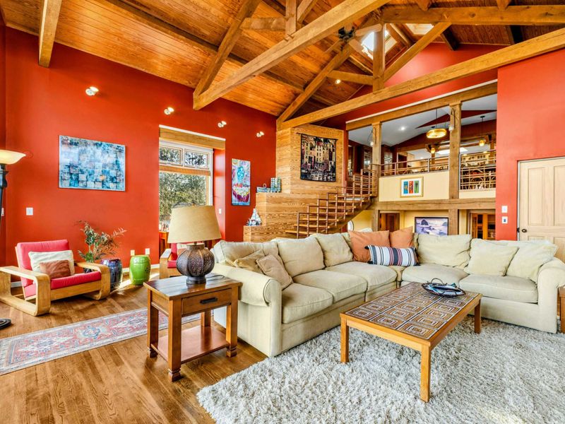Enjoy the open-concept Great Room with soaring wood-beamed ceilings, a plush sectional, and warm natural light. The perfect space to relax, gather, and take in the beauty of Lake Anna.