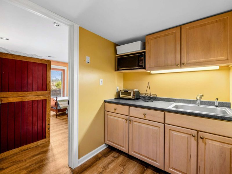 Convenient Kitchenette in Game Room - This handy kitchenette features a sink, microwave, mini-fridge, and storage—perfect for grabbing snacks and drinks while enjoying the game room or relaxing after a day on Lake Anna.