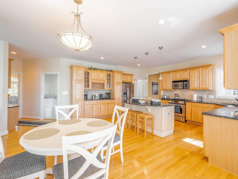 4 person dining set and island seating, adjacent to breezeway with more seating