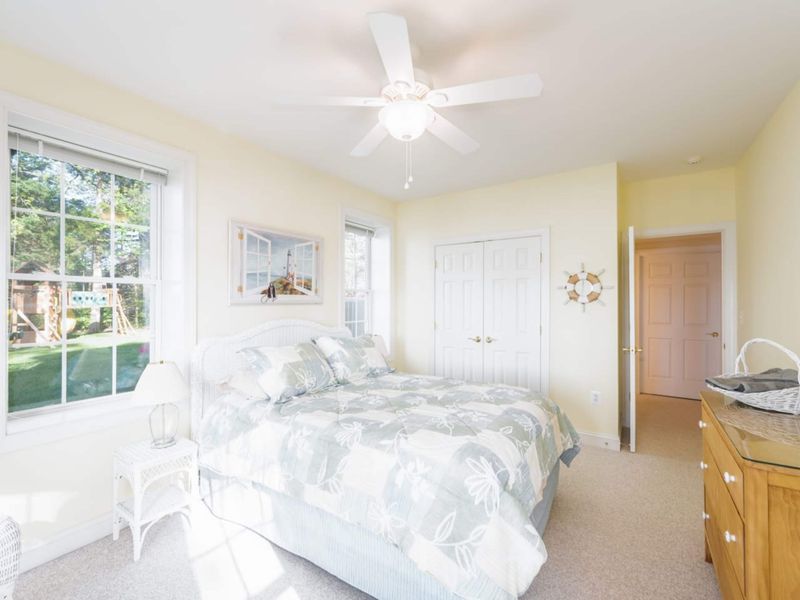 The beach room in the basement! Comfortable bedding, lake views and a full bathroom right outside your door! This room also has access to the backyard/lake!