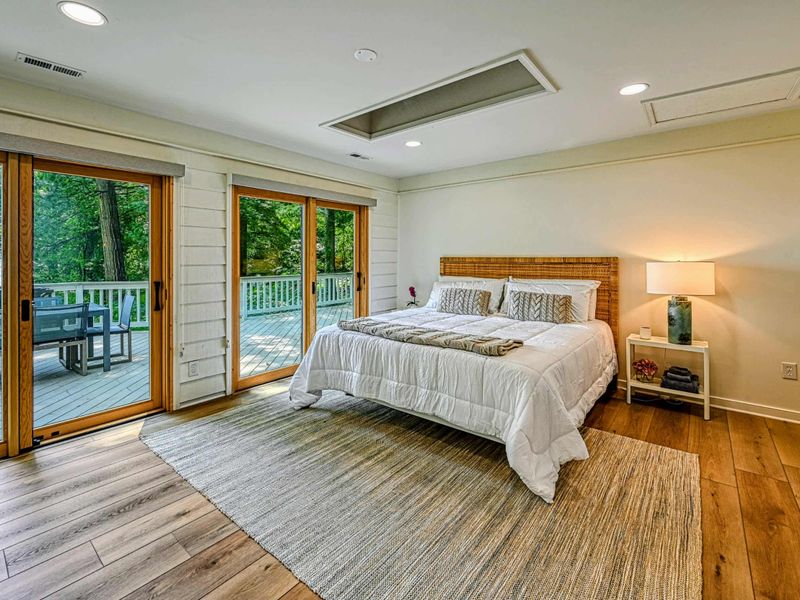 Lakeview Bedroom Suite: A spacious bedroom suite with calming views of Lake Anna and minimalist décor.
