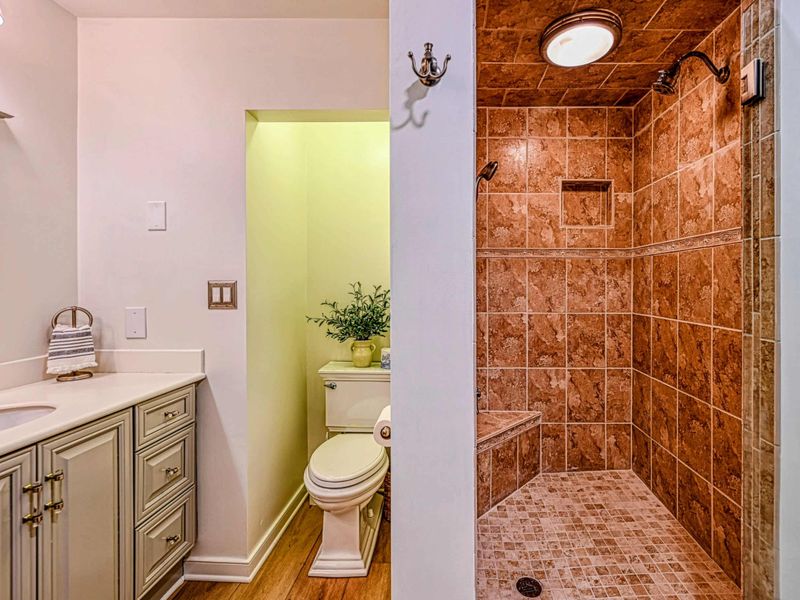 Attached Primary Bathroom: Modern fixtures in a private bathroom near the Lake Anna retreat.