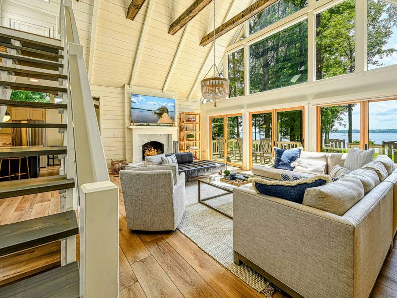 Living Room View: Stunning Lake Anna views framed by floor-to-ceiling windows inside the house.
