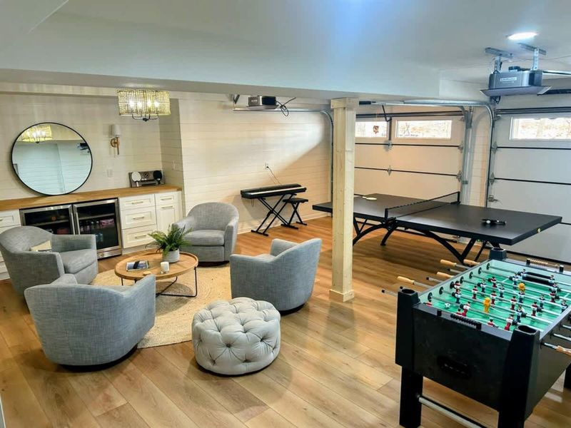Garage-turned-Game Room – Enjoy ping pong, foosball, and a cozy lounge with a built-in bar in this stylish entertainment space!