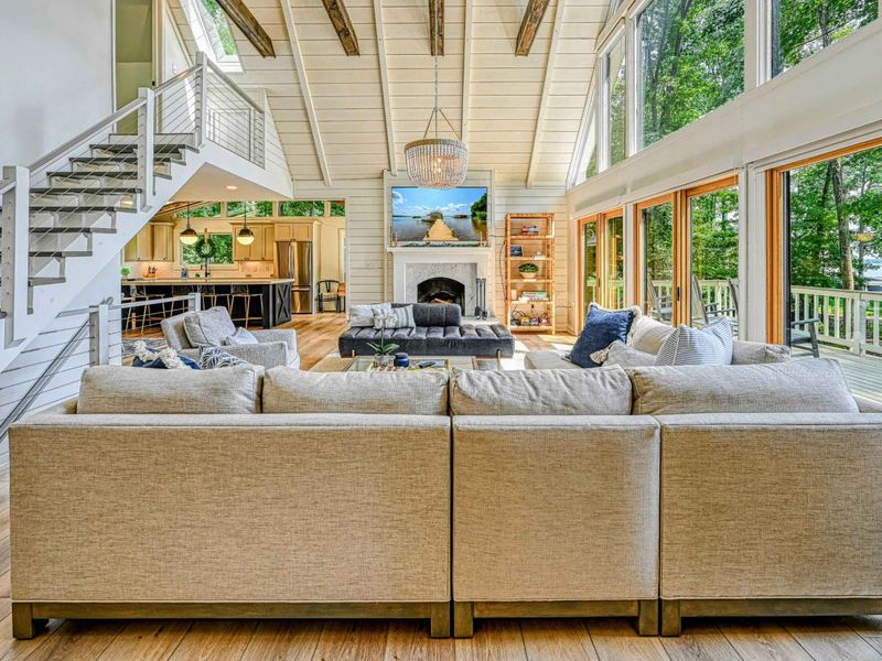 Vaulted Ceilings: A striking interior featuring wooden beams and tall ceilings with Lake Anna visible through the windows.