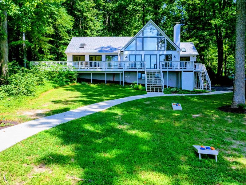 Cottage View: A cozy view of the house nestled amidst towering trees near Lake Anna.