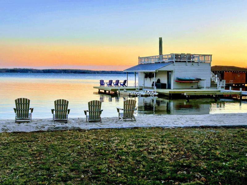 Sunset at the Lake: Watch vibrant skies reflect on Lake Anna as you relax in Adirondack chairs on the private beach, with your private dock just steps away for the perfect end to the day.
