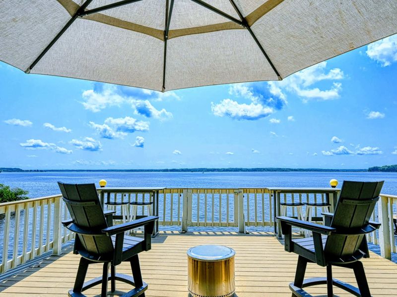 Cozy Deck Nook: A shaded seating area on the dock upper deck with sweeping Lake Anna views.