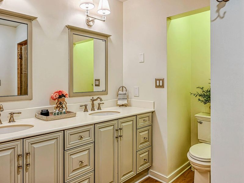 Attached Primary Bathroom: Modern fixtures in a private bathroom near the Lake Anna retreat.