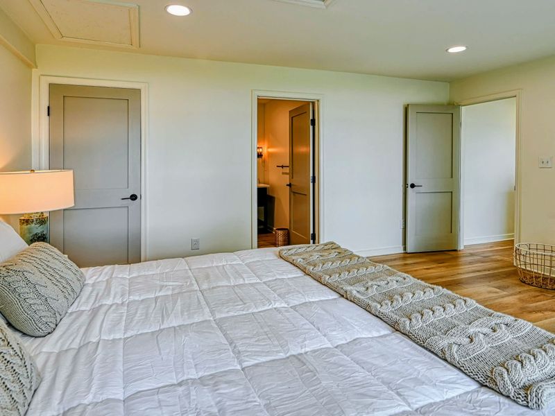 Lakeview Bedroom Suite: A spacious bedroom suite with calming views of Lake Anna and minimalist décor.