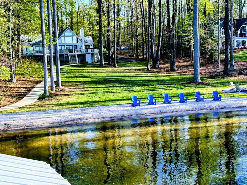 Lakeside lawn and home: A gently sloped, tree-lined yard leads from the water’s edge to your beautiful lake house—perfect for lawn games, family time, and easy access to Lake Anna.