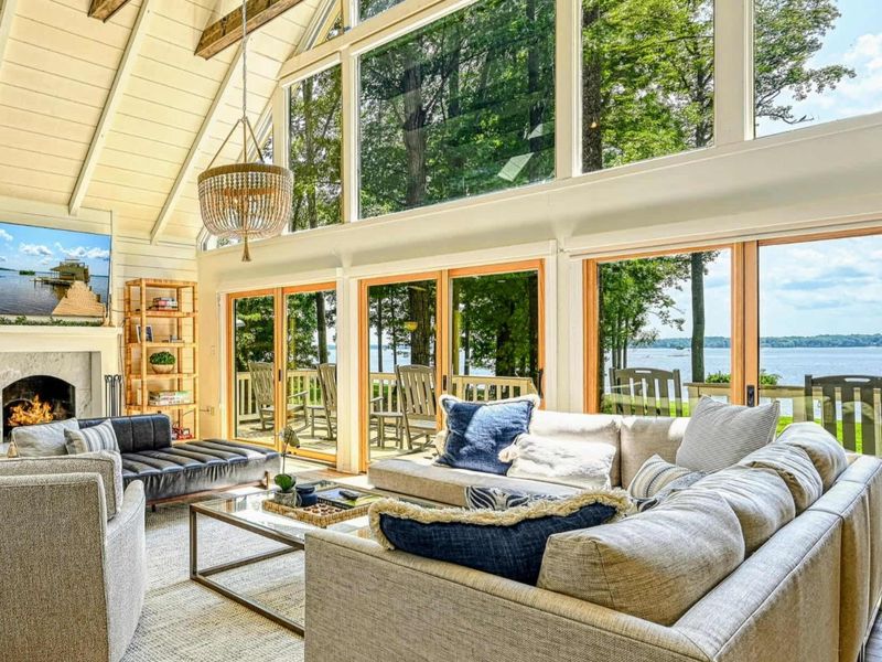 Living Room View: Stunning Lake Anna views framed by floor-to-ceiling windows inside the house.
