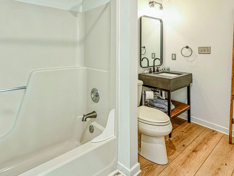 Shared Bathroom: A clean and spacious bathroom, perfect for family use during your Lake Anna getaway.