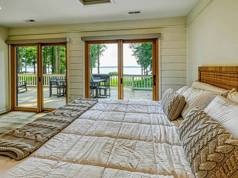 Lakeview Bedroom Suite: A spacious bedroom suite with calming views of Lake Anna and minimalist décor.