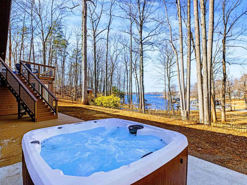 Hot Tub Escape – Warm, bubbling waters with a backdrop of trees and sky.