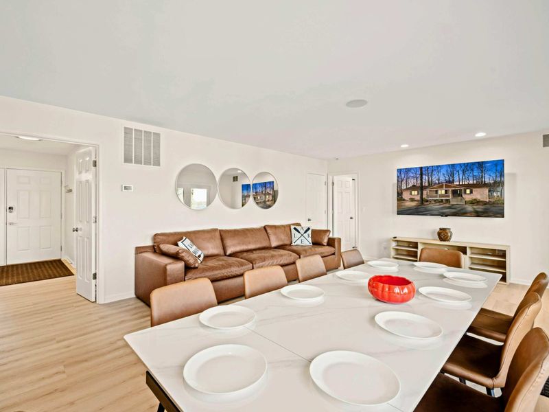 Open & Elegant – A seamless flow from dining to living with warm tones.